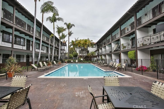 pool featuring a patio and fence