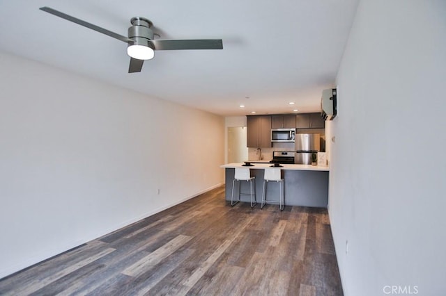 17200 Newhope St Unit 206, Fountain Valley, CA 92708 - kitchen with appliances with stainless steel finishes, dark wood-style flooring, a peninsula, light countertops, and recessed lighting