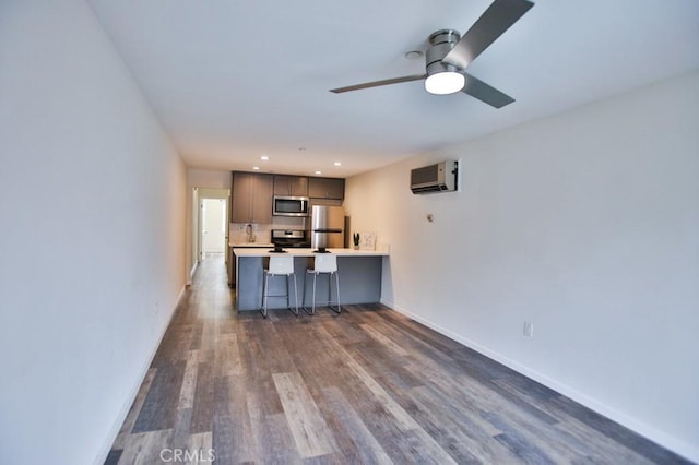 17200 Newhope St Unit 206, Fountain Valley, CA 92708 - kitchen with stainless steel appliances, an AC wall unit, gray cabinets, dark wood-type flooring, and recessed lighting