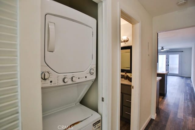 17200 Newhope St Unit 206, Fountain Valley, CA 92708 - laundry room featuring stacked washer / dryer, dark wood finished floors, and a ceiling fan