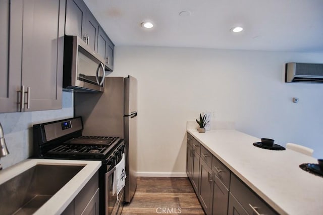 17200 Newhope St Unit 206, Fountain Valley, CA 92708 - kitchen featuring stainless steel appliances, a wall mounted air conditioner, dark wood-style floors, light countertops, and recessed lighting