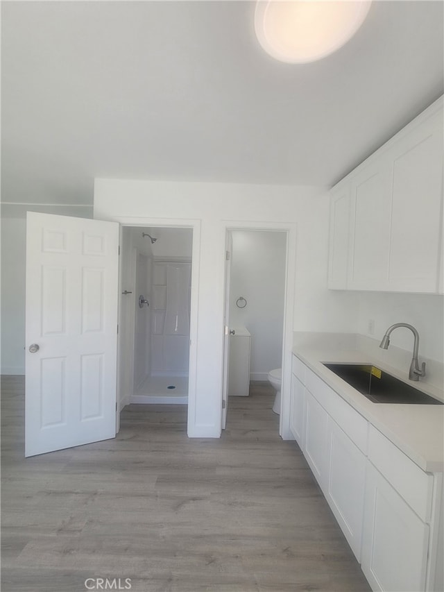 6221 Fishburn Ave, Bell, CA 90201 - interior space featuring toilet, a stall shower, baseboards, wood finished floors, and vanity
