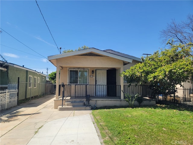 6221 Fishburn Ave, Bell, CA 90201 - view of front of house featuring a porch, a front lawn, fence, and stucco siding