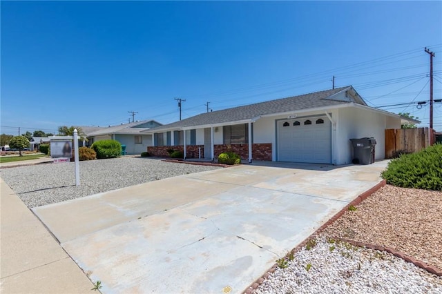 28590 Middlebury Way, Menifee, CA 92586 - ranch-style home with a garage, driveway, covered porch, fence, and stucco siding