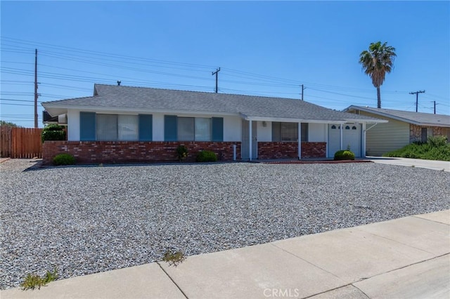 28590 Middlebury Way, Menifee, CA 92586 - ranch-style house featuring an attached garage, driveway, brick siding, fence, and a shingled roof