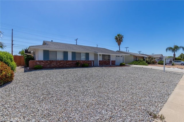 28590 Middlebury Way, Menifee, CA 92586 - ranch-style home featuring an attached garage, brick siding, fence, and concrete driveway