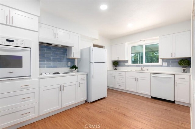 28590 Middlebury Way, Menifee, CA 92586 - kitchen with white appliances, a sink, backsplash, white cabinetry, and under cabinet range hood
