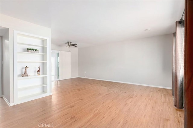 28590 Middlebury Way, Menifee, CA 92586 - unfurnished living room with light wood finished floors, built in shelves, and baseboards