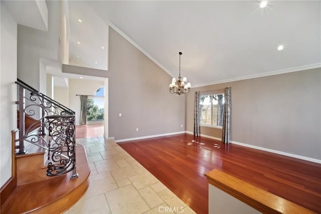 interior space featuring a chandelier, high vaulted ceiling, stairs, and ornamental molding