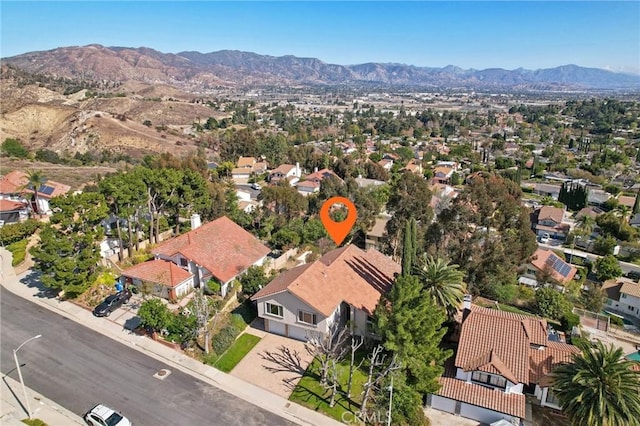 birds eye view of property with a mountain view and a residential view
