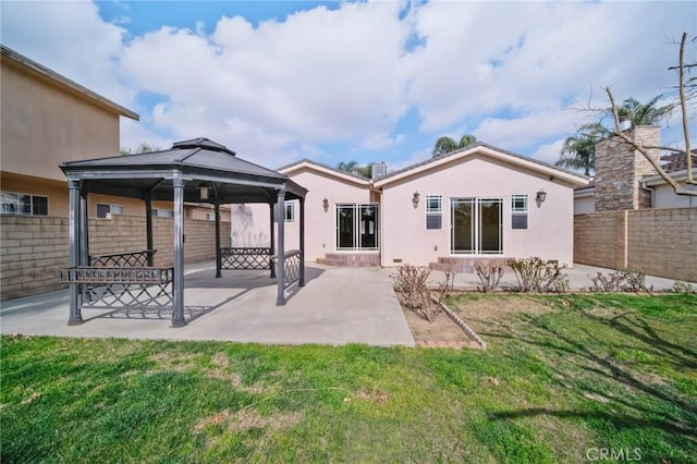 back of house featuring a gazebo, fence, a patio area, a yard, and stucco siding