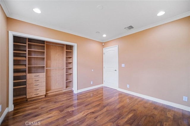 unfurnished bedroom with baseboards, dark wood-style flooring, and visible vents