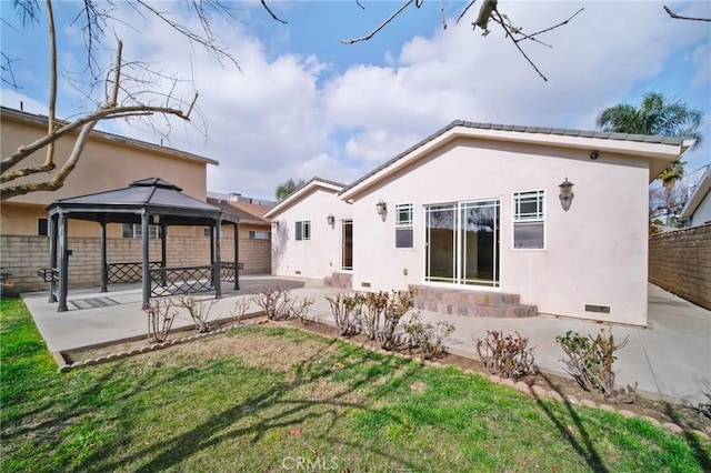 back of house with a gazebo, fence, a patio, entry steps, and stucco siding
