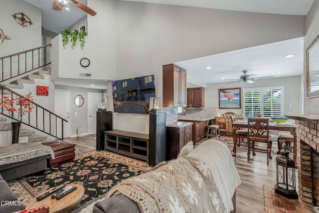 2752 Lemon Dr, Simi Valley, CA 93063 - living room with ceiling fan, high vaulted ceiling, stairway, and wood finished floors