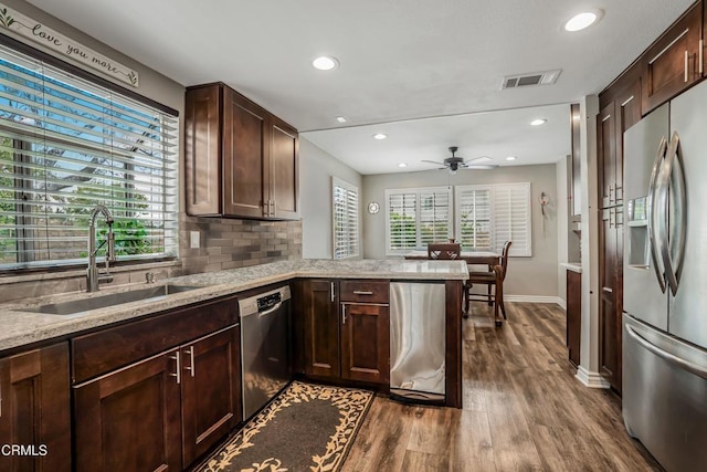 2752 Lemon Dr, Simi Valley, CA 93063 - kitchen featuring appliances with stainless steel finishes, recessed lighting, dark wood finished floors, dark brown cabinets, and light stone counters
