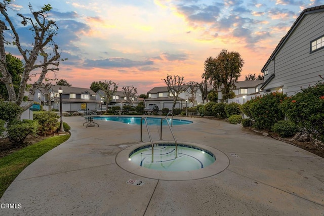 2752 Lemon Dr, Simi Valley, CA 93063 - pool at dusk with a hot tub, a residential view, a patio area, and a community pool