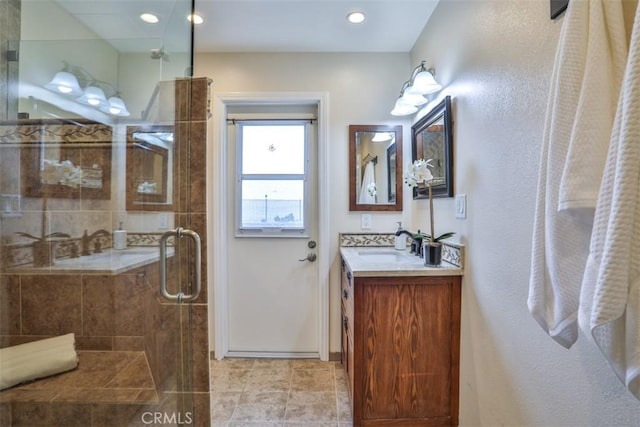 bathroom featuring vanity, baseboards, recessed lighting, tile patterned floors, and a stall shower
