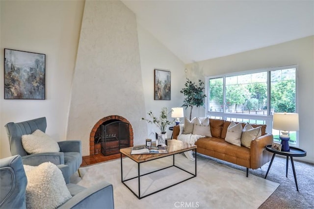 living area featuring carpet, a brick fireplace, and high vaulted ceiling