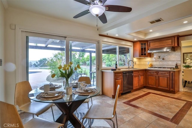 kitchen featuring brown cabinets, visible vents, ornamental molding, and dishwasher