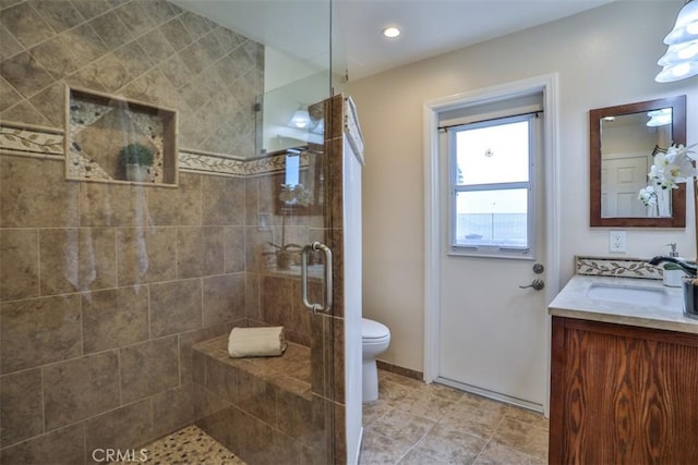 full bath featuring vanity, tile patterned floors, a stall shower, and toilet