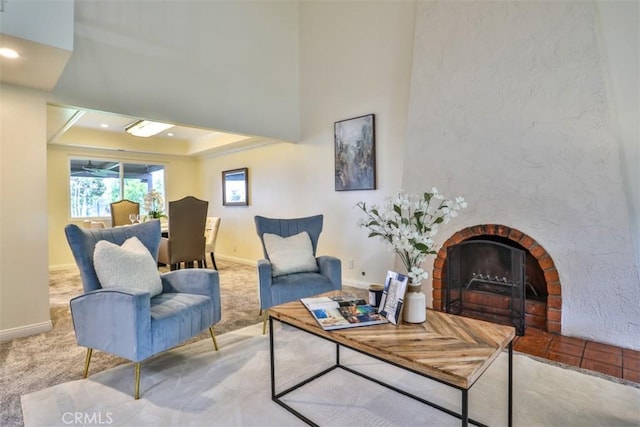 living area with recessed lighting, baseboards, carpet, and a fireplace