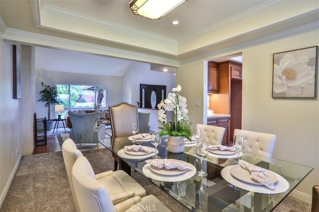 dining space with carpet floors, ornamental molding, baseboards, recessed lighting, and a tray ceiling