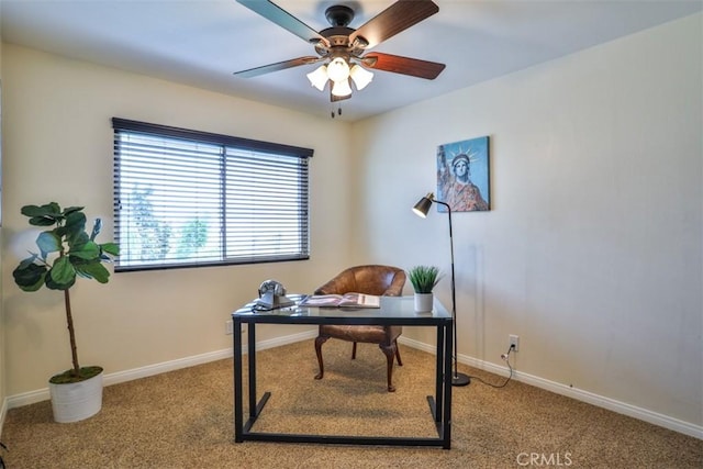 carpeted home office featuring baseboards and ceiling fan