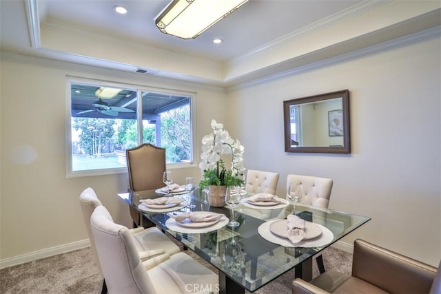 dining room featuring a raised ceiling, baseboards, carpet floors, and visible vents