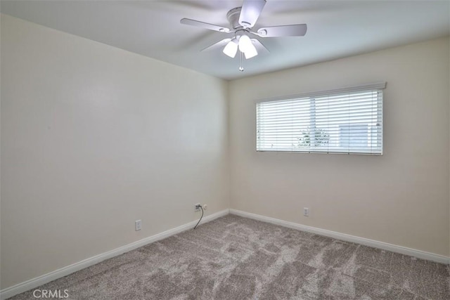 unfurnished room with baseboards, a ceiling fan, and carpet