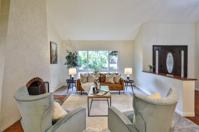 living room with baseboards and lofted ceiling