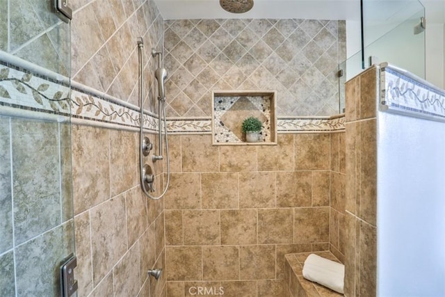 bathroom with a tile shower