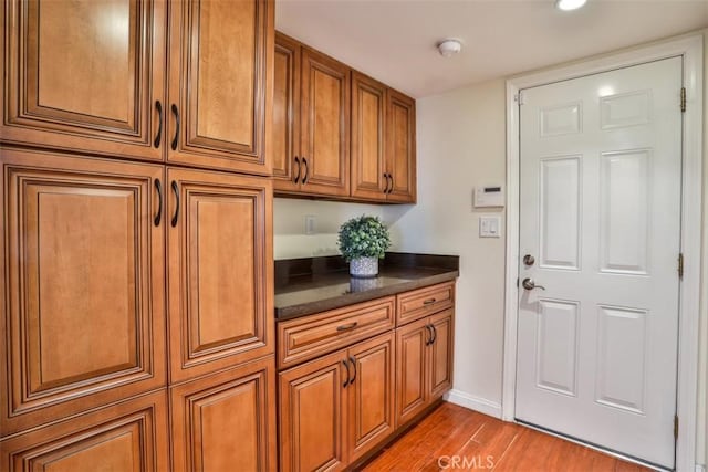 interior space with recessed lighting, baseboards, and wood finished floors