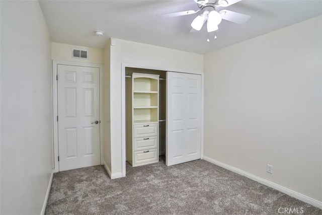 unfurnished bedroom featuring baseboards, carpet, a closet, and visible vents