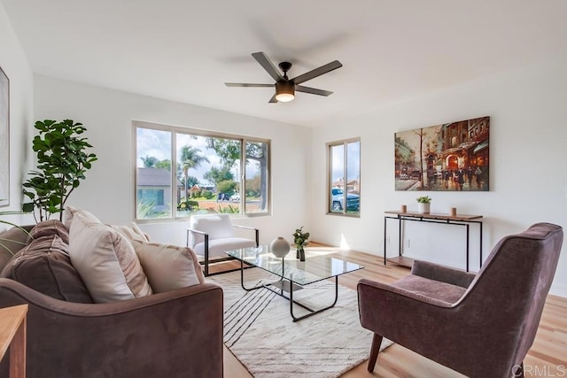 living room with light wood-style flooring and ceiling fan