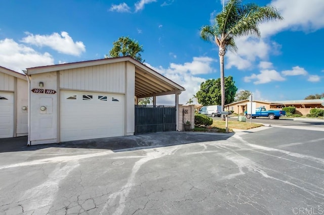 garage with driveway and fence