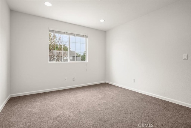 empty room with recessed lighting, carpet floors, and baseboards