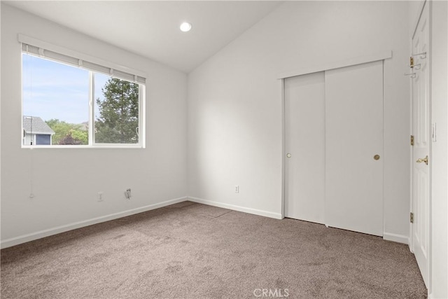 unfurnished bedroom with recessed lighting, baseboards, vaulted ceiling, and carpet