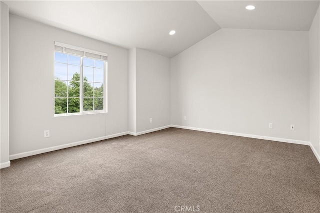 empty room featuring recessed lighting, dark carpet, and lofted ceiling