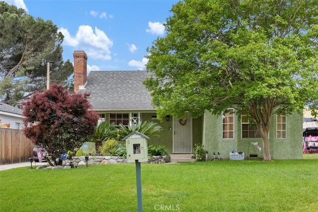3432 N Arrowhead Ave, San Bernardino, CA 92405 - view of property hidden behind natural elements featuring a chimney, roof with shingles, and stucco siding