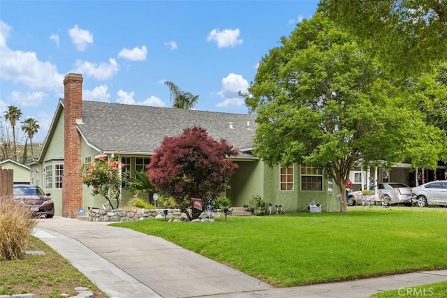 3432 N Arrowhead Ave, San Bernardino, CA 92405 - view of front facade with a front lawn, driveway, a shingled roof, and stucco siding