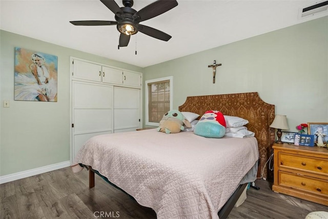 3432 N Arrowhead Ave, San Bernardino, CA 92405 - bedroom featuring dark wood-type flooring, baseboards, a ceiling fan, and a closet