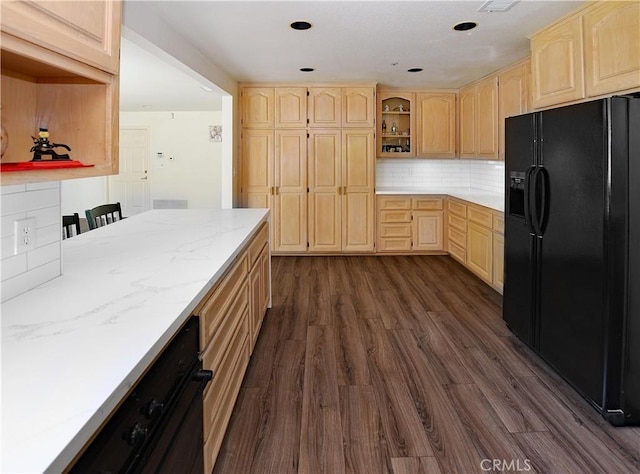 kitchen with black refrigerator with ice dispenser, dark wood finished floors, and light brown cabinets