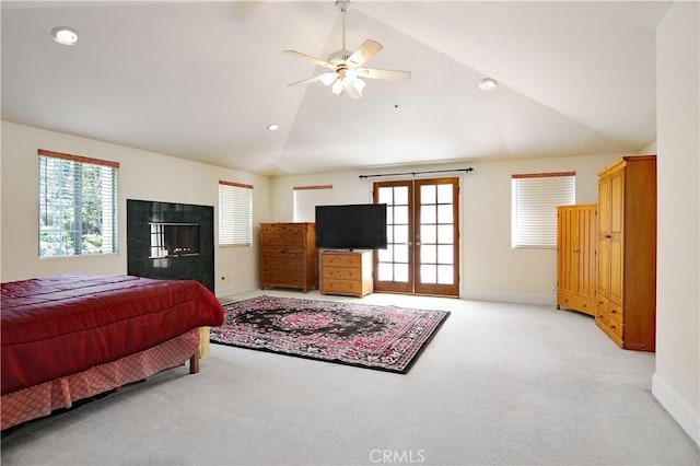 bedroom featuring lofted ceiling, baseboards, and light carpet