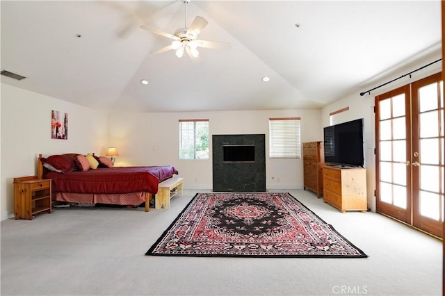 bedroom featuring light colored carpet, lofted ceiling, french doors, and visible vents