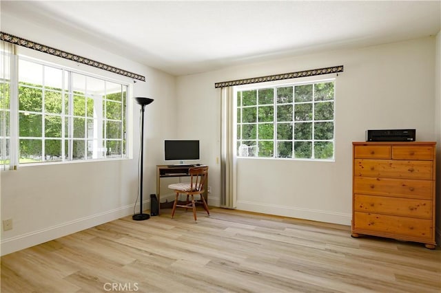 office area with light wood-style flooring and baseboards