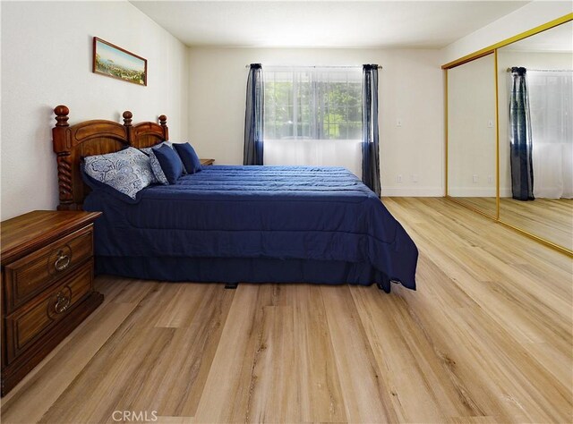 bedroom with a closet and light wood-style flooring