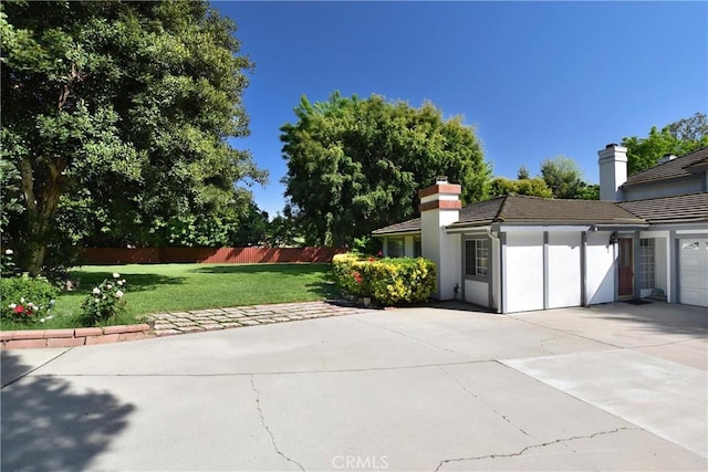 exterior space with fence and driveway