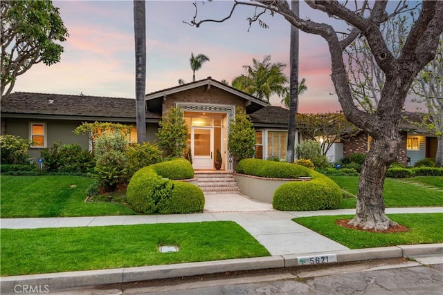 view of front of home with a front yard and stucco siding