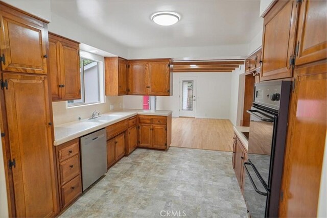 6833 Sultana Ave, San Gabriel, CA 91775 - kitchen with dishwasher, brown cabinets, light countertops, and a warming drawer