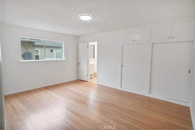 6833 Sultana Ave, San Gabriel, CA 91775 - unfurnished bedroom featuring wood finished floors, a closet, a textured ceiling, and ensuite bathroom